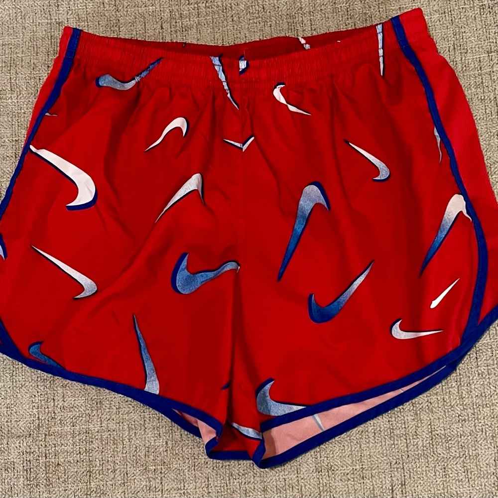 Nike Red Athletic Shorts with Curved Hem and Swoosh Pattern